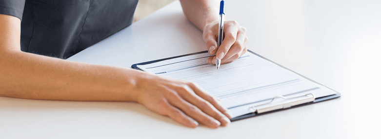 person writing at desk