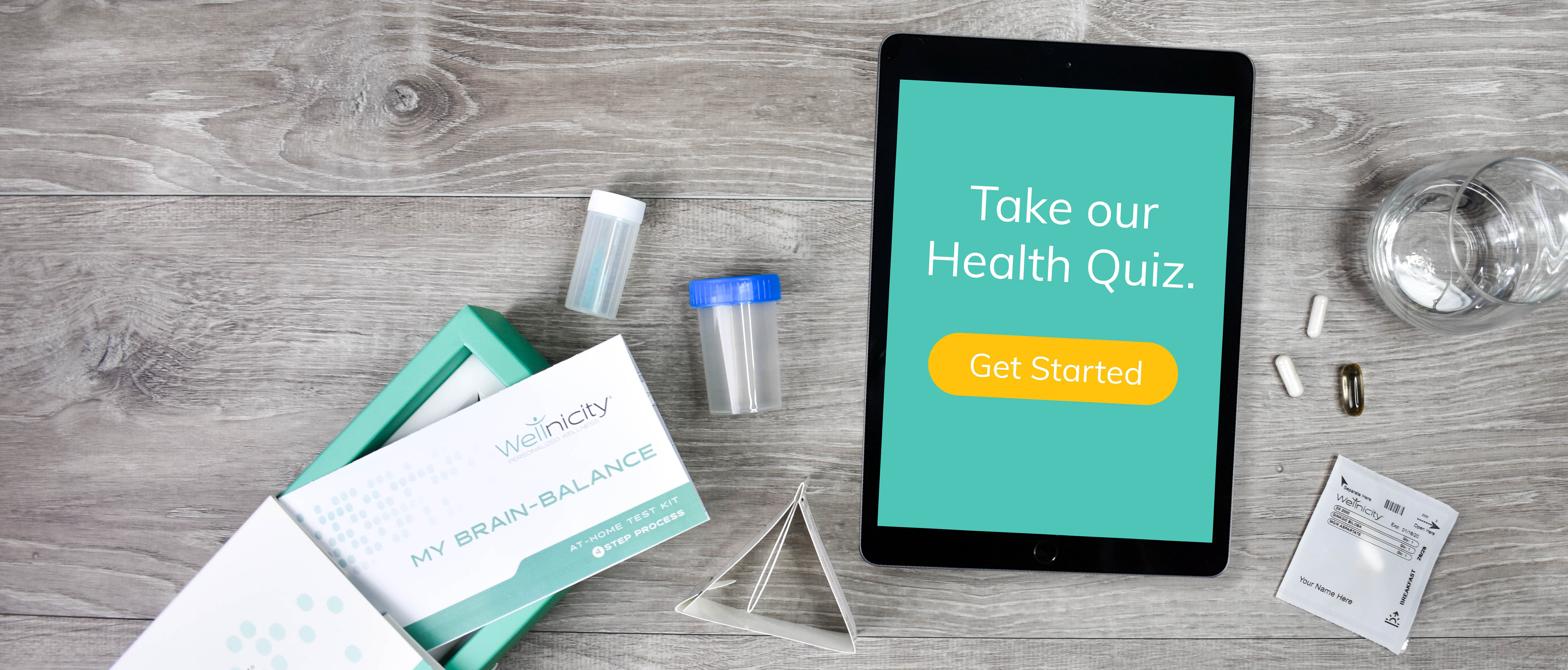 photo of tabletop with test kit, pill packs and tablet with health quiz